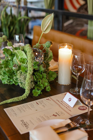 Green disco ball centerpiece at a private event at Carne in Denver