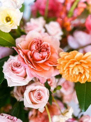 Close-up of a bouquet of colorful flowers including roses at Plum Social floral studio in Denver, Colorado.